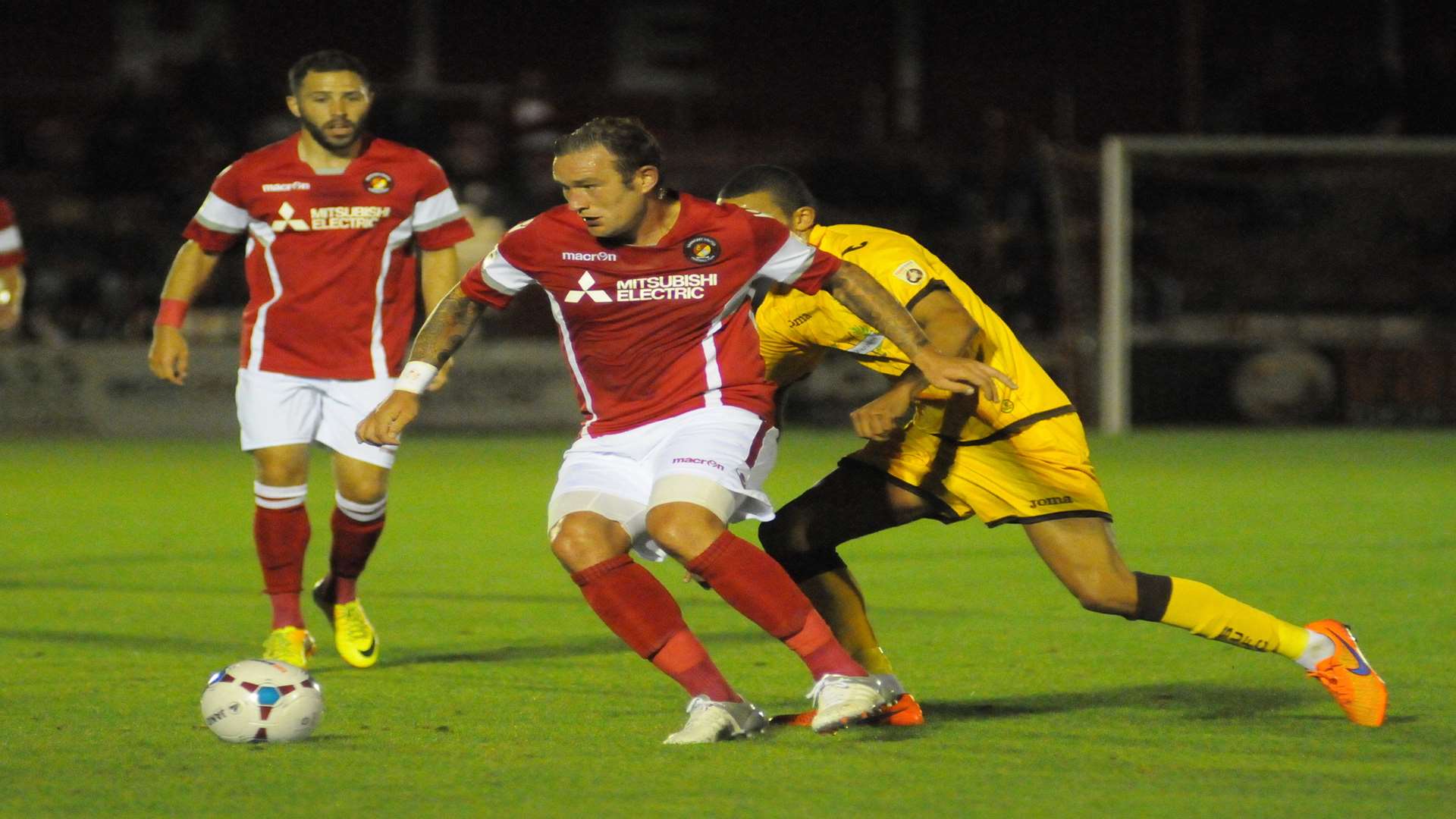 Danny Kedwell holds off his man as Robbie Willmott looks on Picture: Steve Crispe