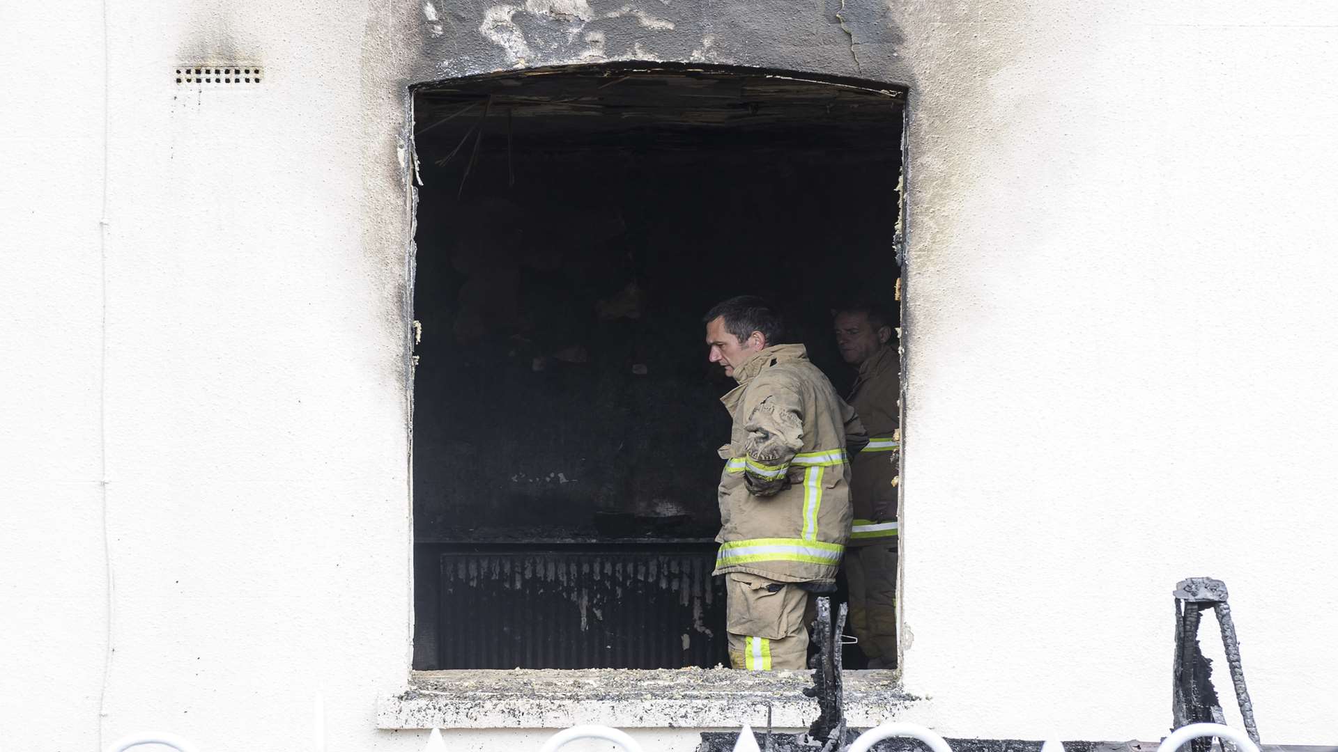 A firefighter stands in the gutted ground floor room of a house seriously damaged by fire in Lucknow Road, Paddock Wood. Picture: Andy Payton