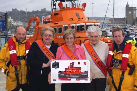 Crew and volunteers with the lifeboat that is being raffled