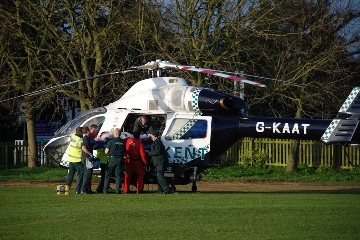 The patient being loaded into the air ambulance