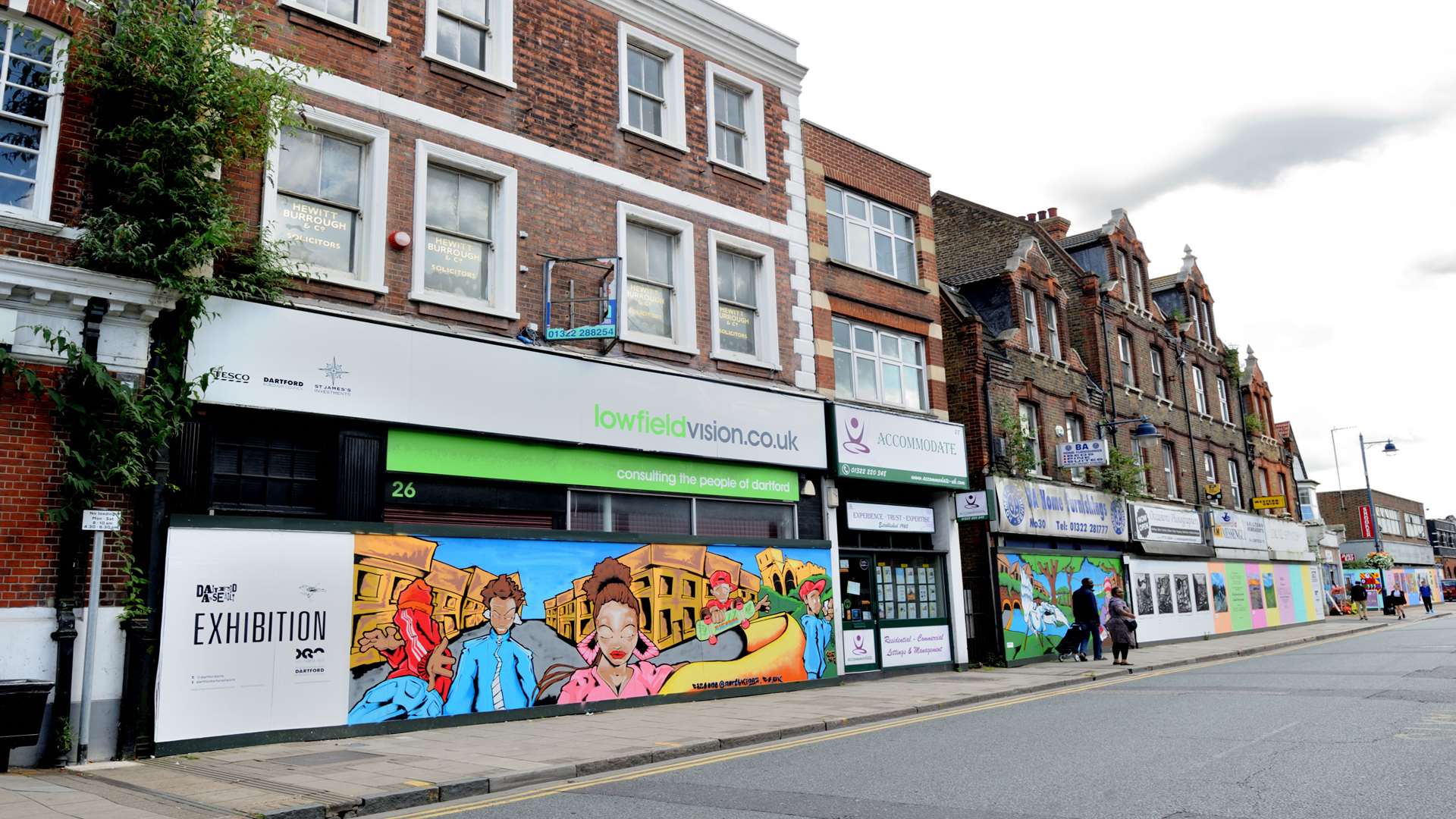 Hoardings were brightened up with artwork but the road is still and eyesore