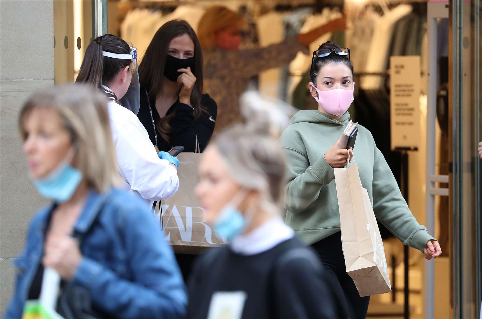 Shoppers in Glasgow where face coverings are already mandatory in stores (Andrew Milligan/PA)