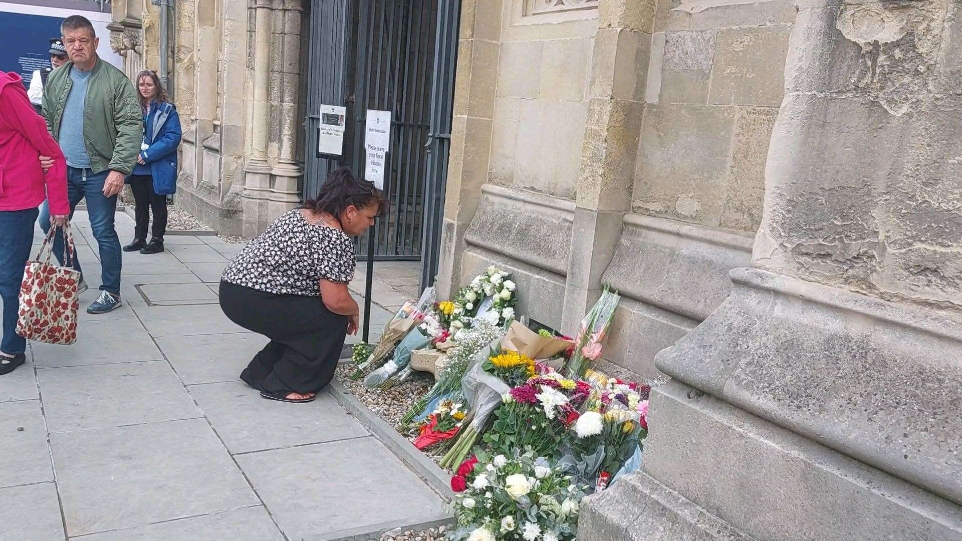 Kirstein Adlington laying flowers outside Canterbury Cathedral
