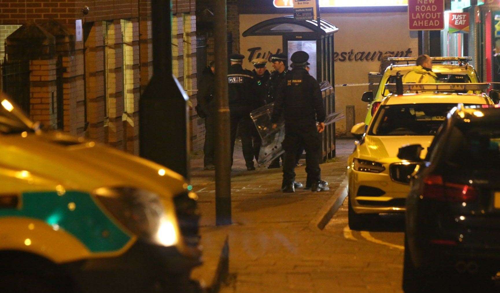Police with riot shields at the scene. Picture: UK News in Pictures