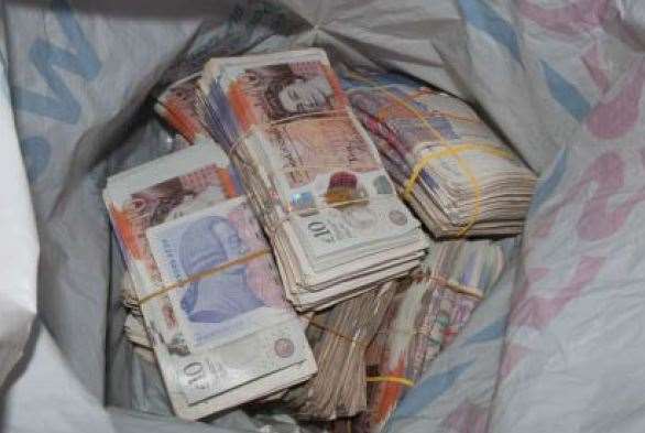 Stash of bank notes found by officers. Stock photo