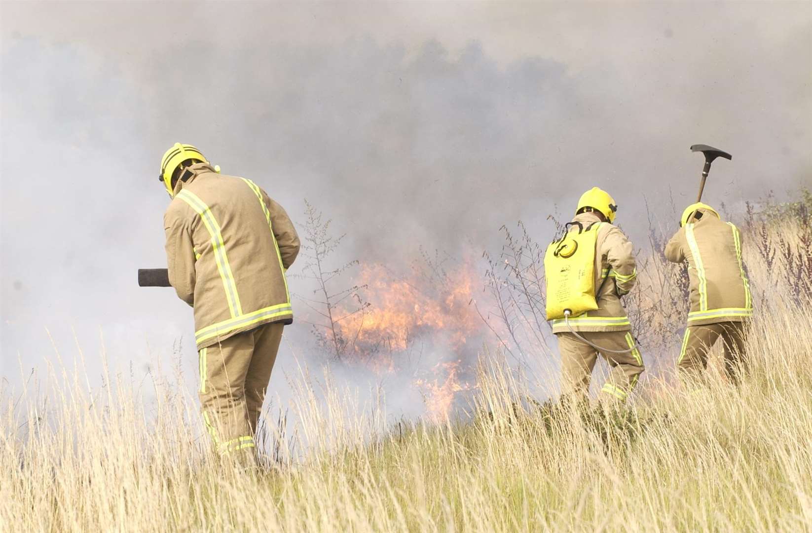 Grassland caught fire between allotments and the railway line. Stock image