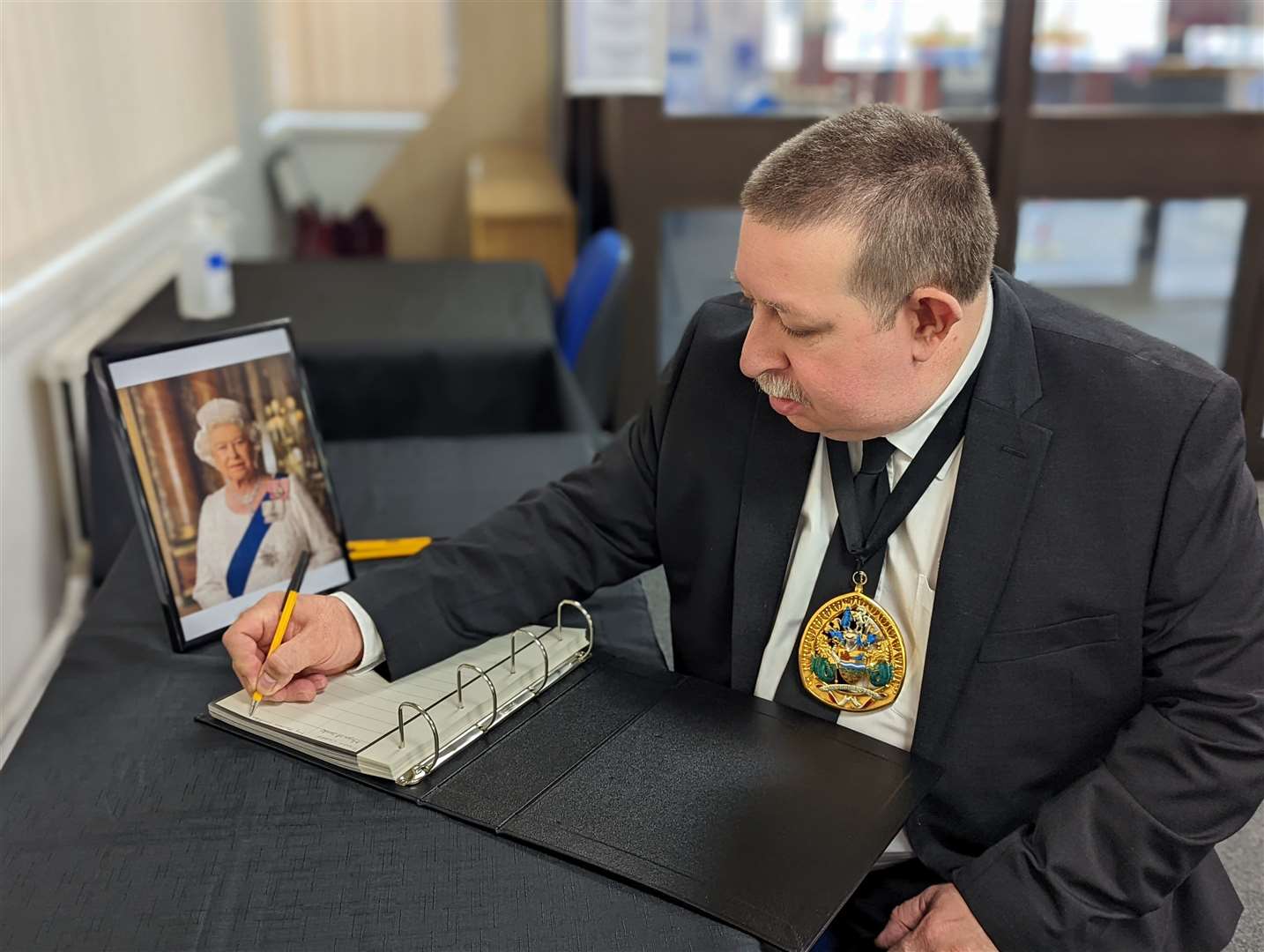 Mayor of Swale Cllr Simon Clark signs a book of condolence at Swale House. Picture: Swale council