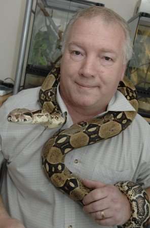 Grant Walker, who is organising a reptile show, with a boa constrictor
