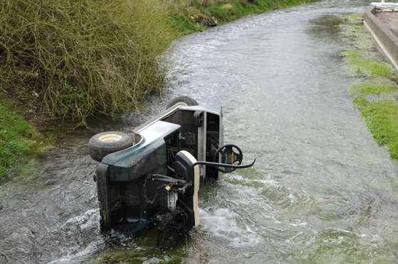 Sitting on its side in the river Nailbourne, this golf cart was stolen from a nearby club