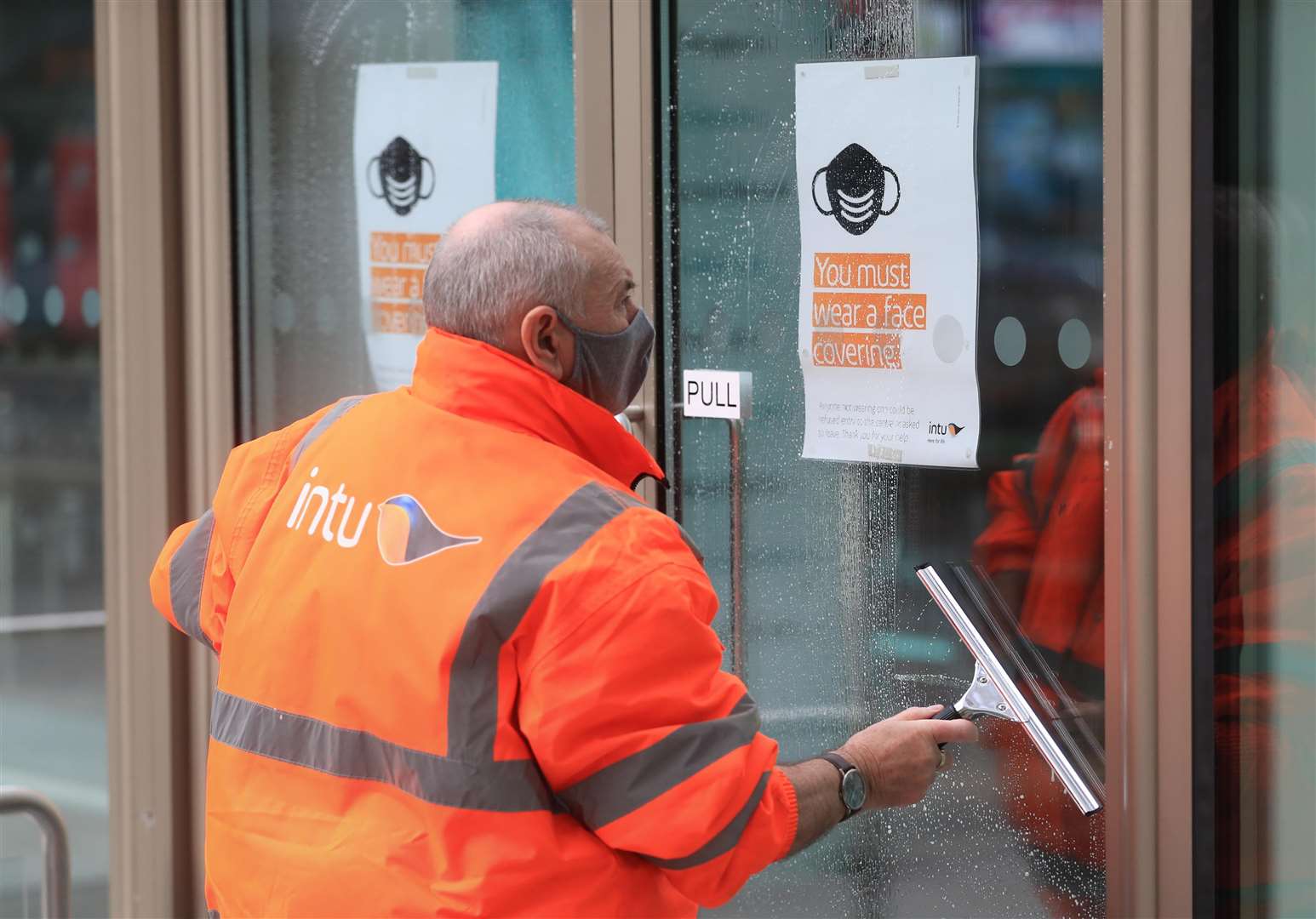 A man cleans a window in Nottingham city centre (Mike Egerton/PA)
