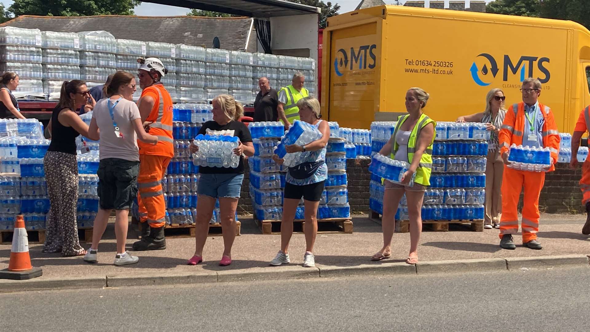 Volunteers ready to load bottles of water into cars at Minster WMC