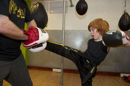 Pint-sized kickboxer Ethan Owers is coached by his dad Jason