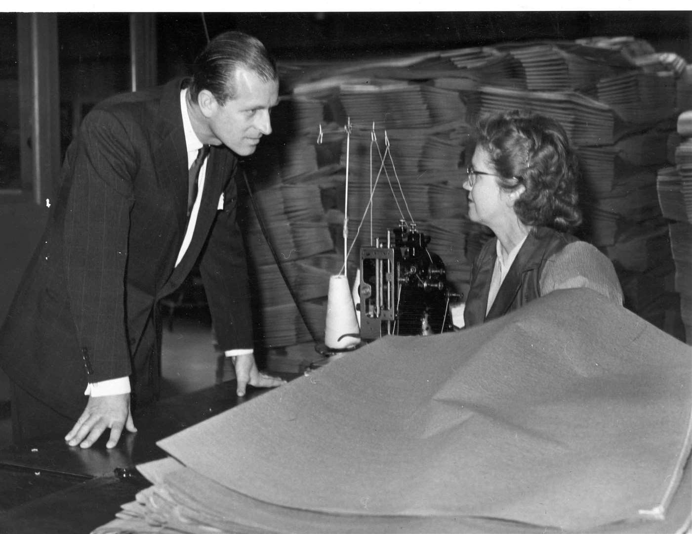 The Duke of Edinburgh toured Reed Paper Group's site at Aylesford in April 1957. He is seen here talking to an operator in the stitching machine room at Medway Paper Sacks
