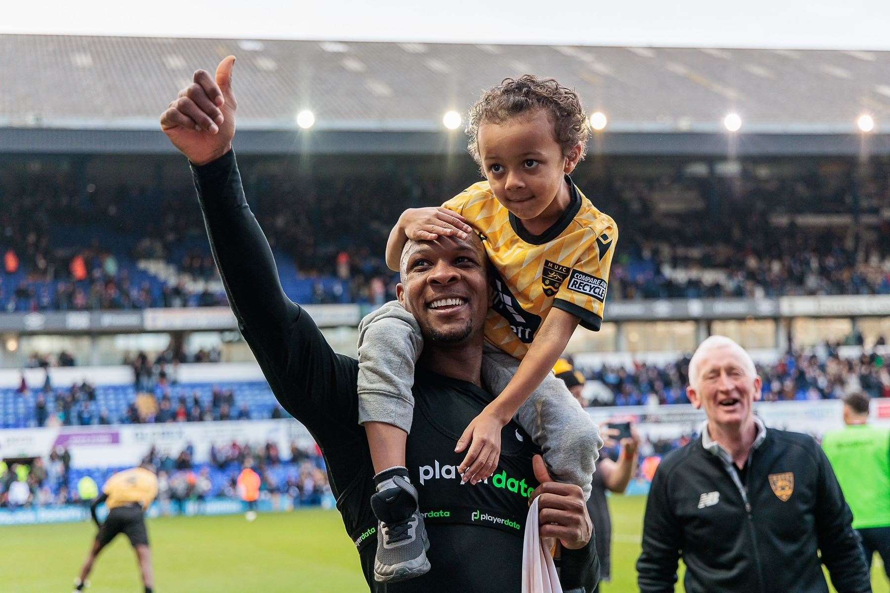 Maidstone captain Gavin Hoyte with his son on the pitch after beating Ipswich. Picture: Helen Cooper