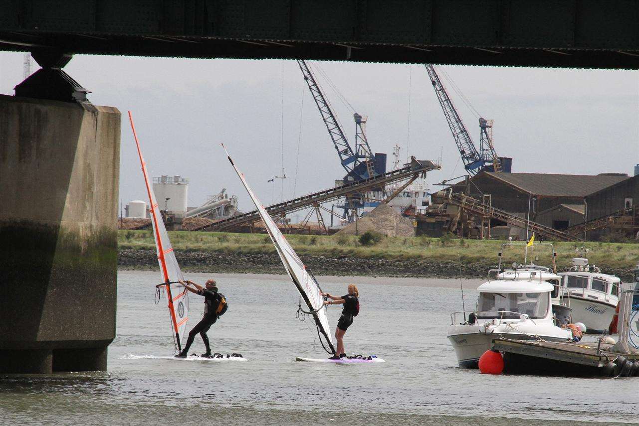 Two windsurfers pass under the Kingsferry Bridge during yesterday's Round the Island race.