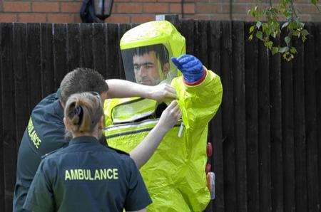 A paramedic wears a protective chemical suite in Manorfield, Singleton