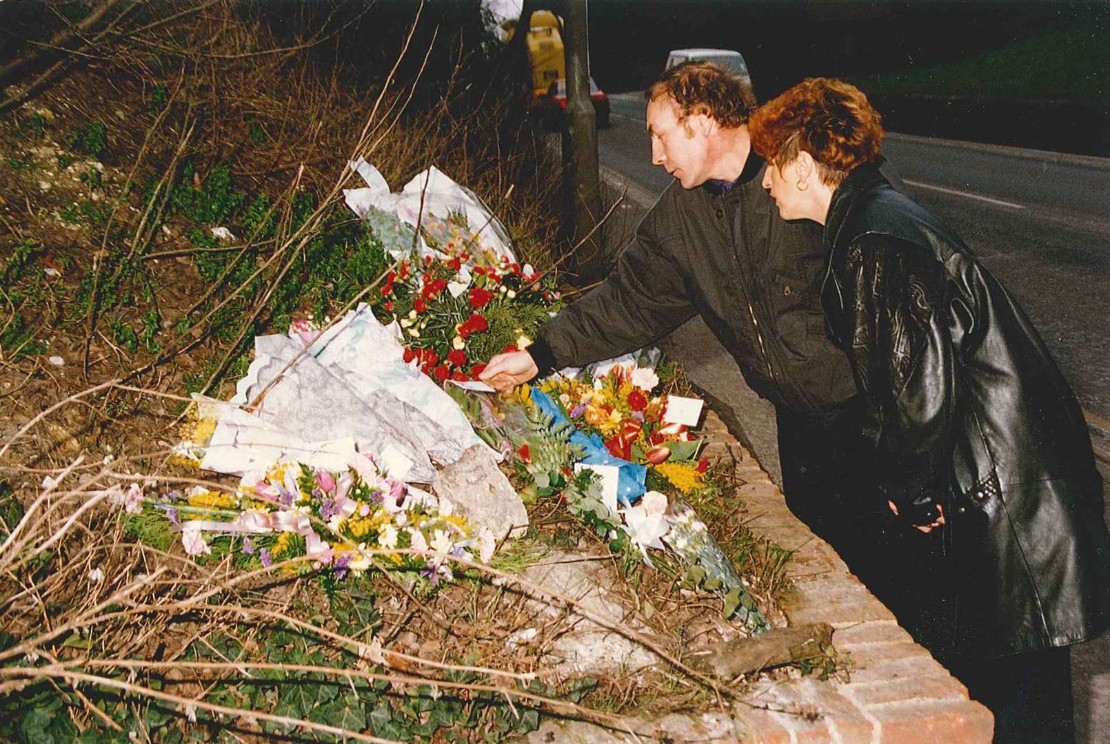 Claire's parents looking at the floral tributes which were left at the scene in 1993