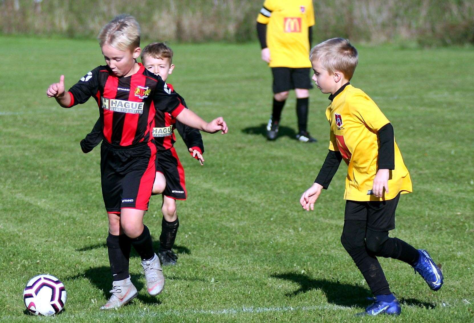 Woodcoombe Youth's under-9s (red/black) battle Thamesview Rangers under-9s Picture: Phil Lee