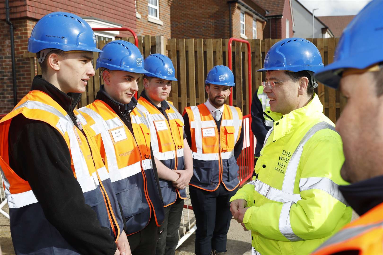 MP James Brokenshire with apprentices from David Wilson Homes