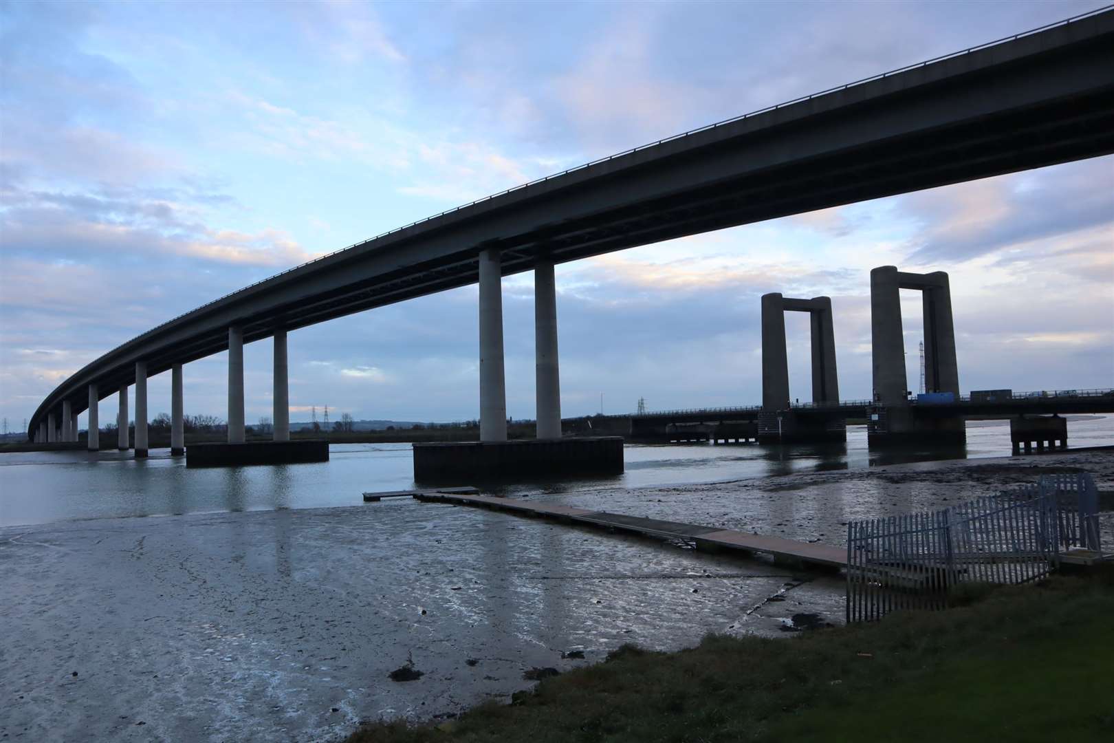 The Kingsferry Bridge dwarfed by the Sheppey Crossing seen from the mainland side of The Swale near Iwade