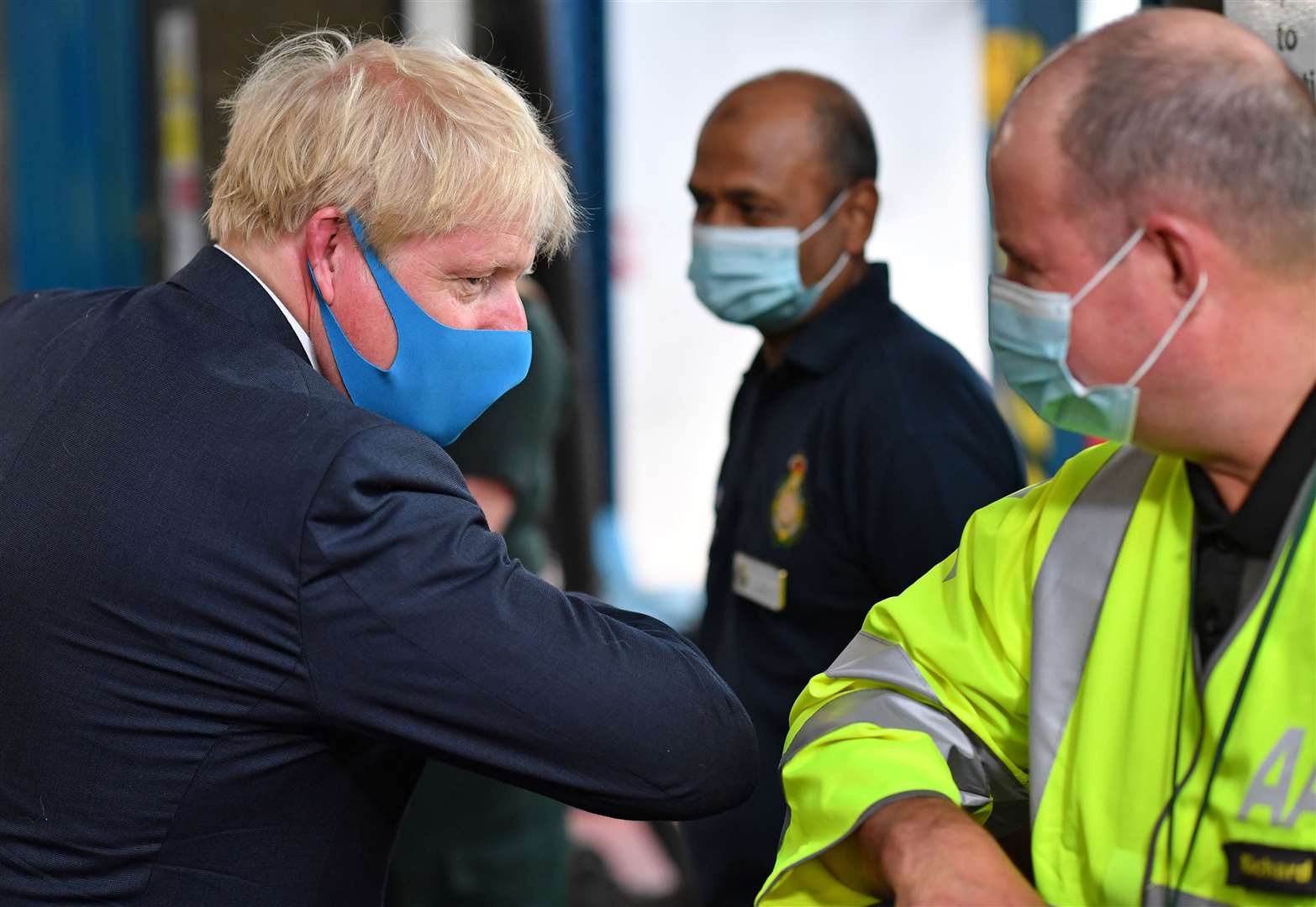 Boris Johnson, wearing a face mask, elbow bumps an employee during a visit to the London Ambulance Service (Ben Stansall/PA)
