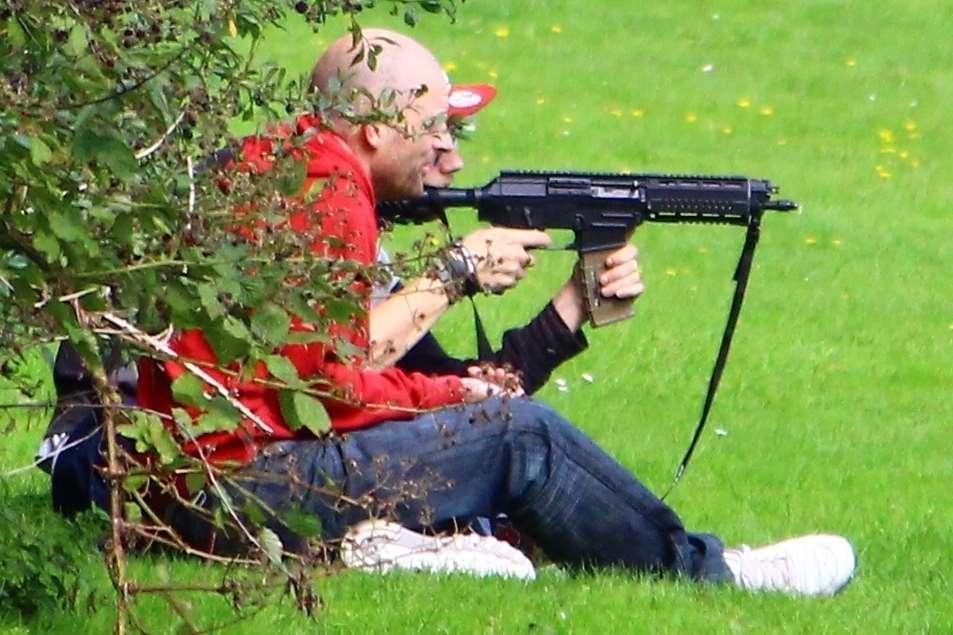 The men were spotted firing the weapon in a park in the middle of the day