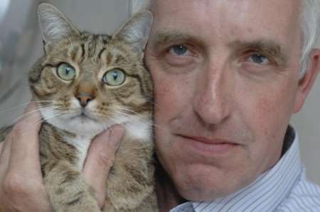 David Day, with cat Thomas, who was shot with an air rifle. Picture by Grant Falvey