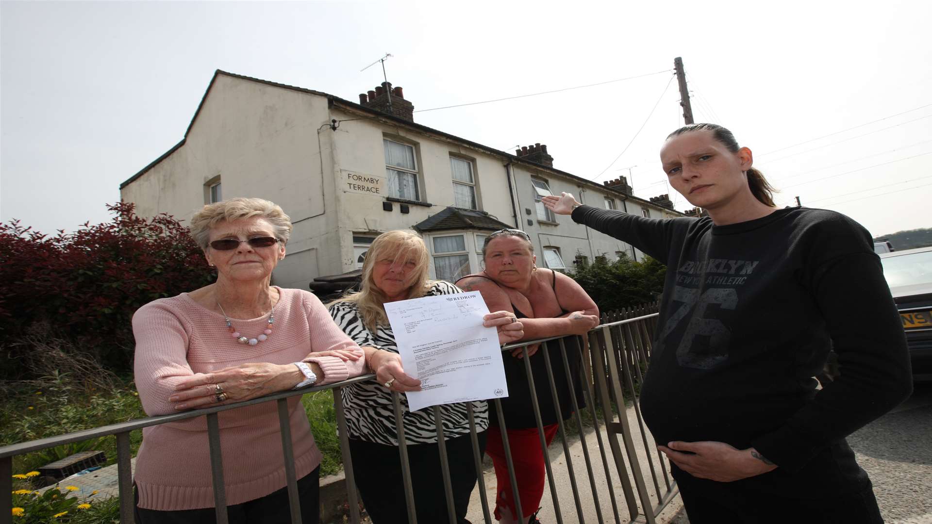 Kayleigh Peachell, in front, and nearly eight months pregnant with other families who live in Formby Terrace.