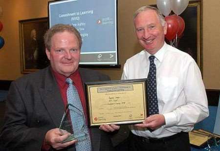 Ray Langley receives his award from Allan Chisholm. Picture courtesy: MAXIM PR & MARKETING