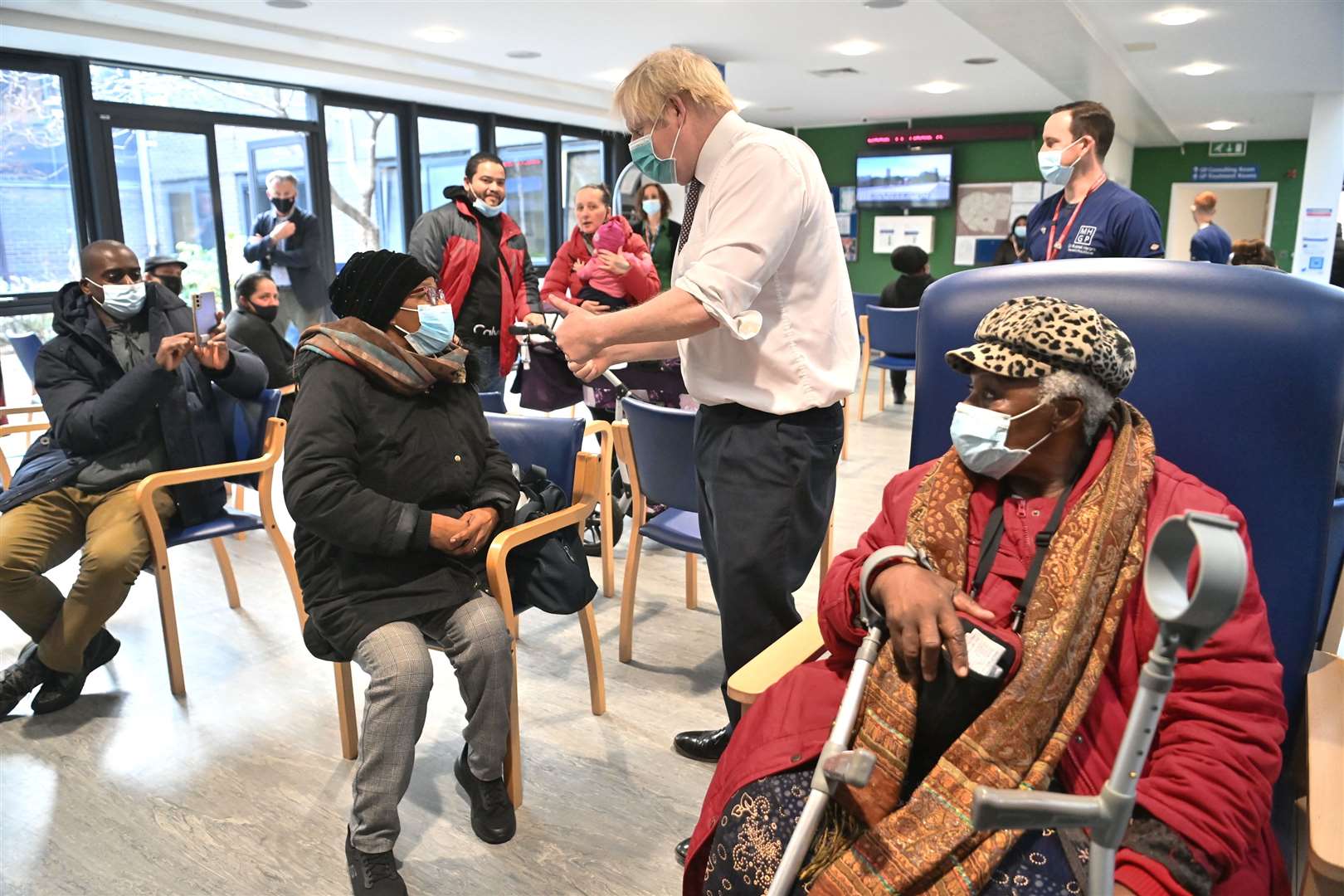 Prime Minister Boris Johnson speaks to a member of the public during a visit to Lordship Lane Primary Care Centre in north London during a booster vaccine session (Paul Grover/Daily Telegraph/PA)