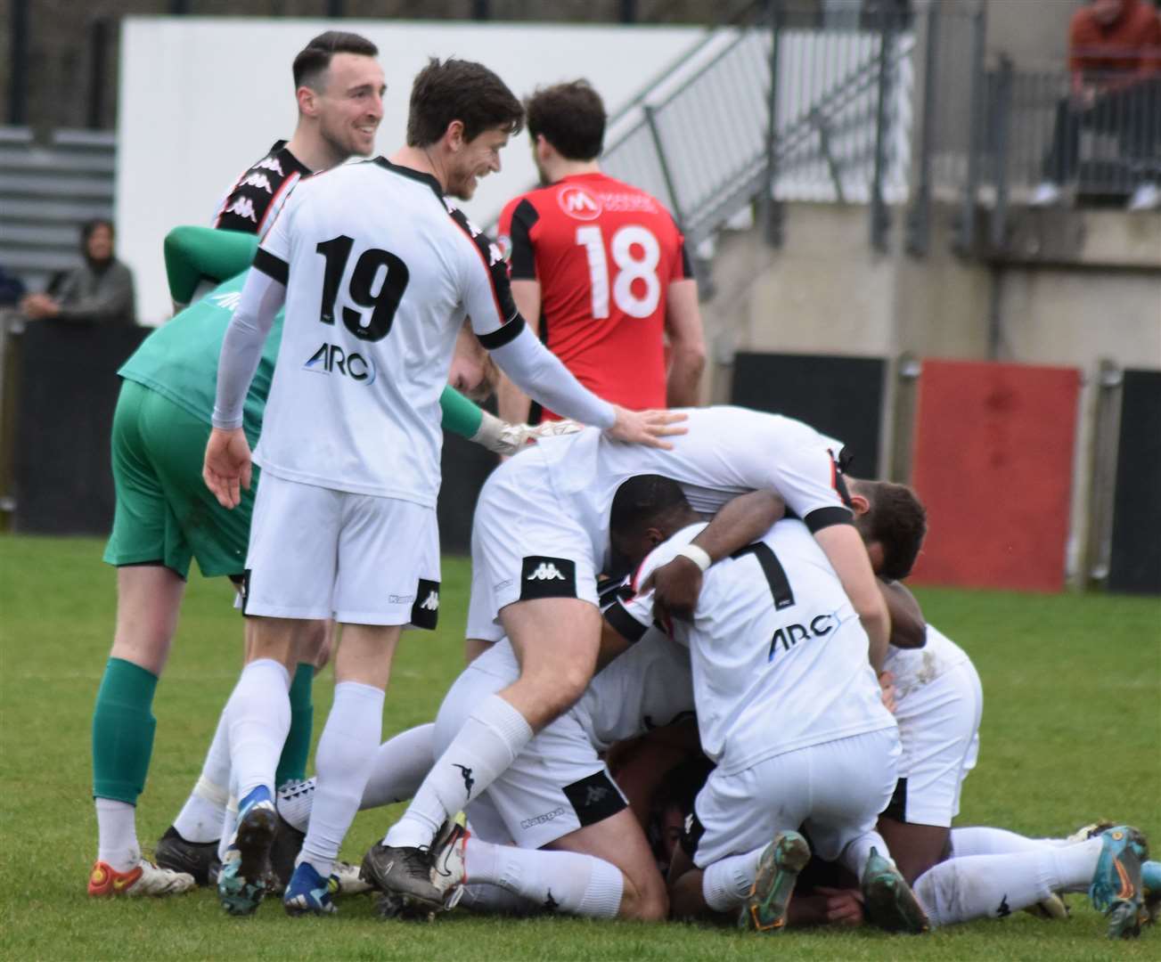 Faversham players celebrate Jake McIntyre's 90th-minute winner at Erith Town. Picture: Alan Coomes