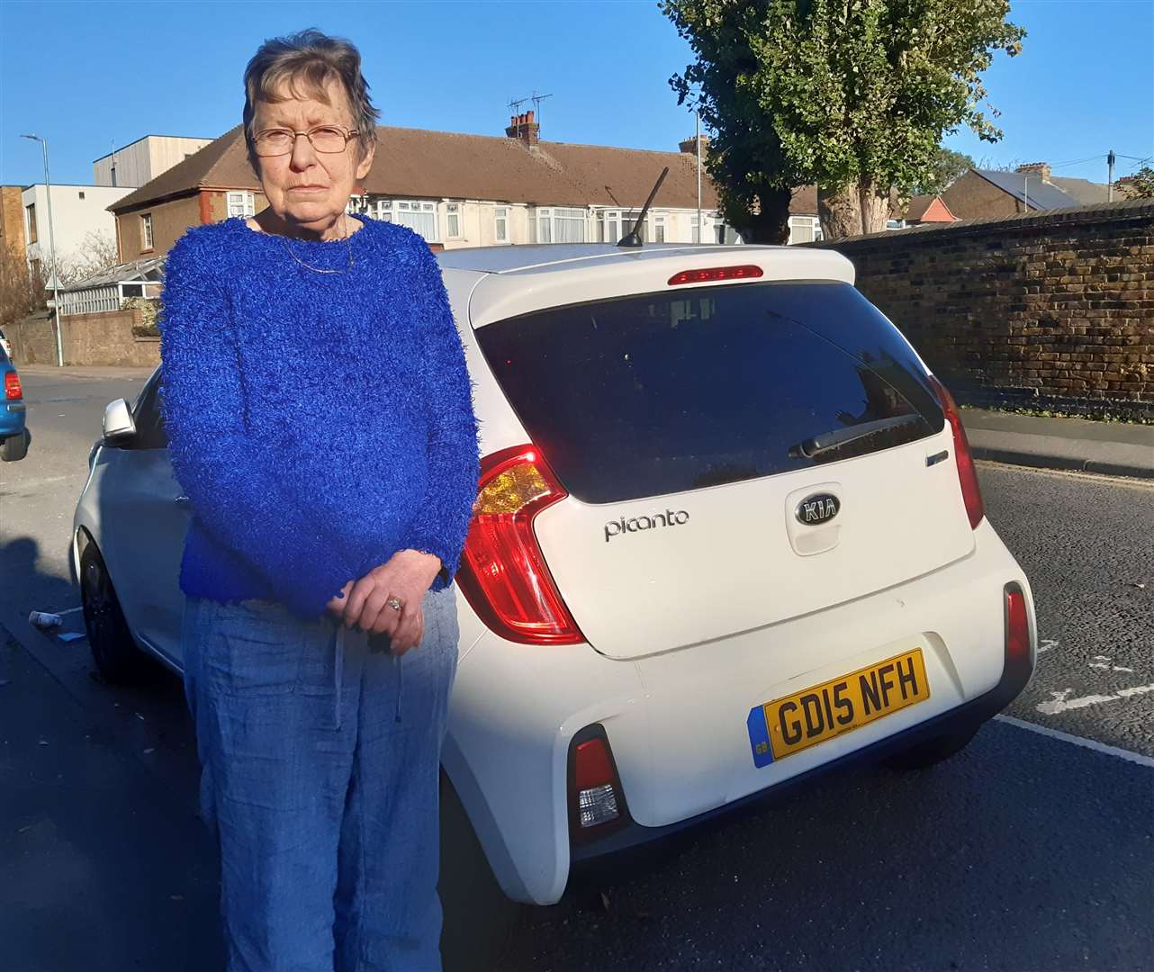 Angry pensioner Ann Taylor with her car