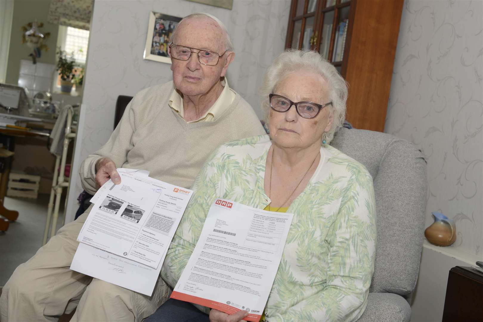 Colin and Margaret Lofting with their parking notice and fines which have caused them so much stress