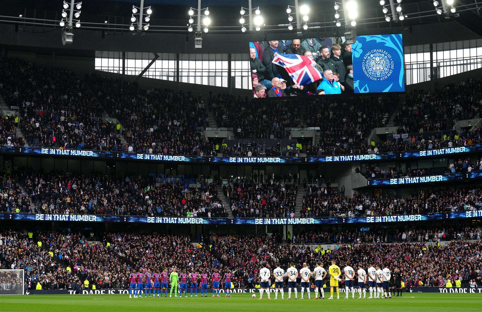 Tottenham Hotspur players stand for the national anthem, to mark the coronation of the King, before their Premier League match against Crystal Palace in London (John Walton/PA)