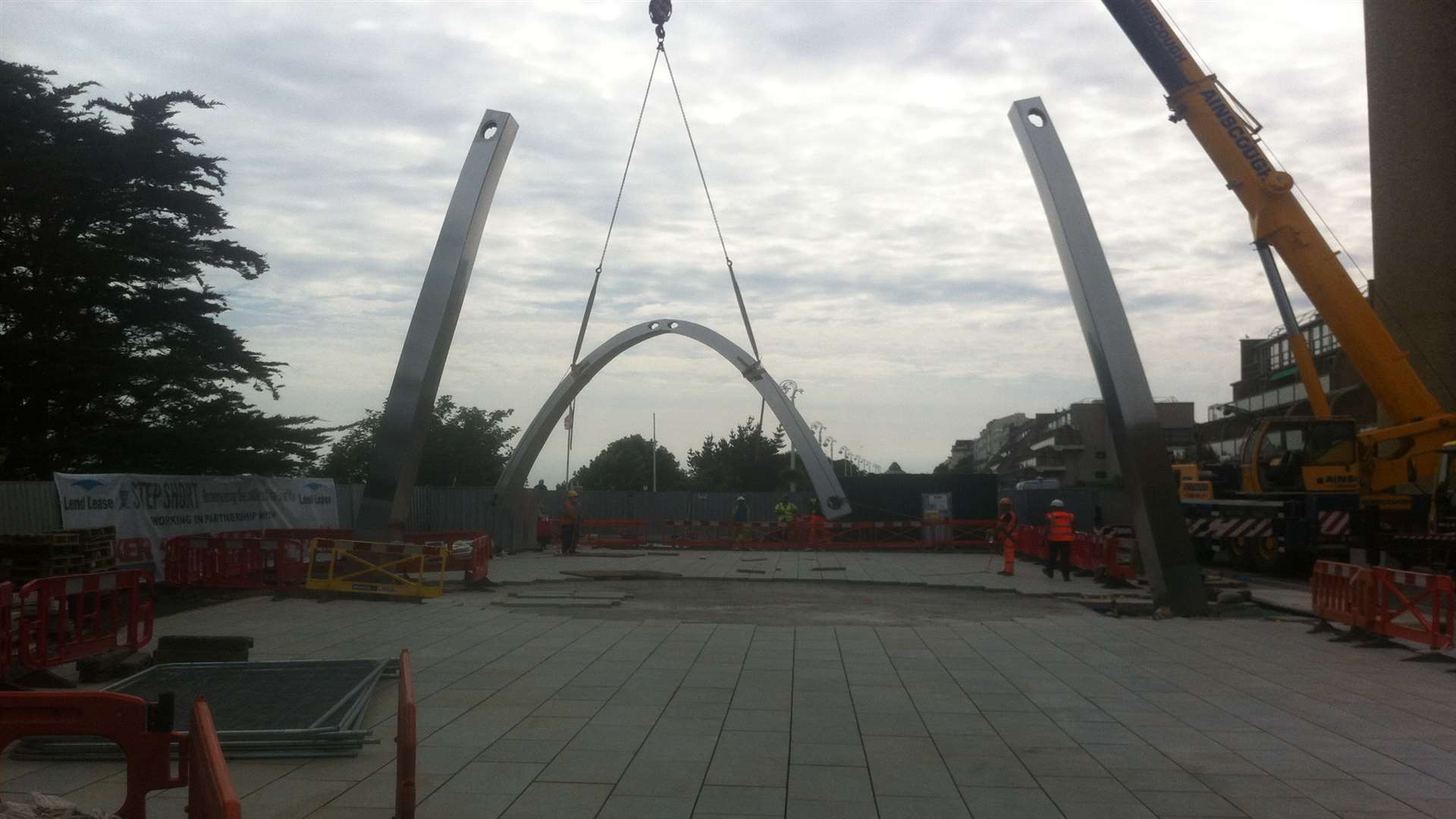 Almost there... workers erect the memorial arch in Folkestone