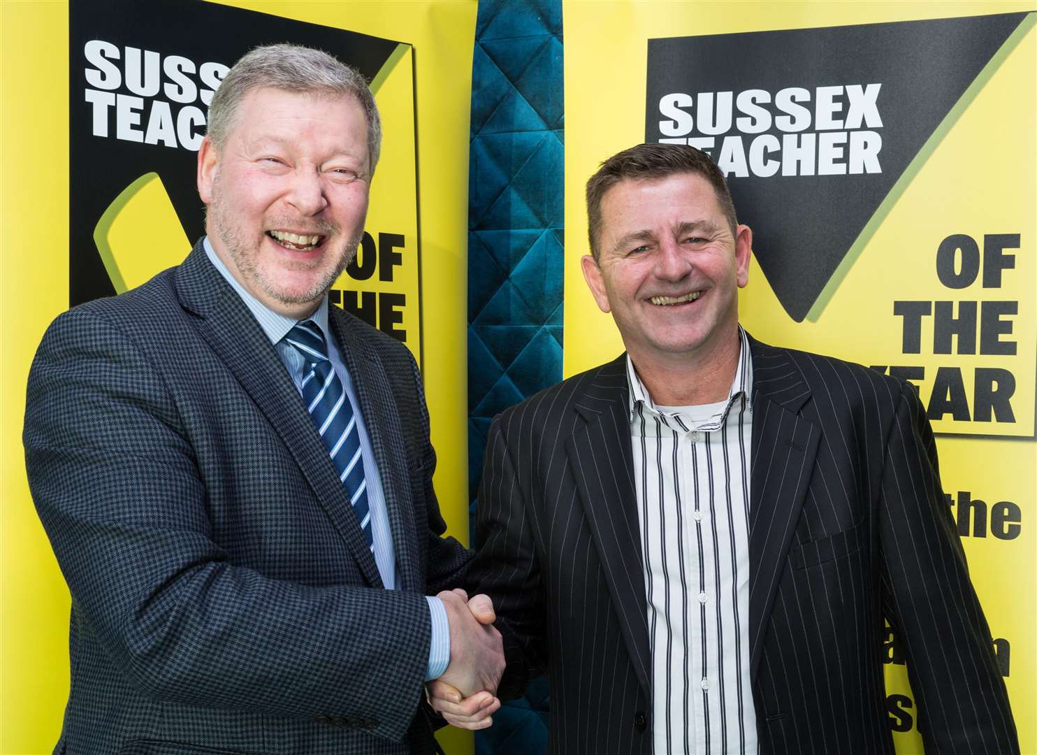 Former CEO Simon Dolby (left) shakes hands with KM Charity Team's new leader Mike Ward. (26963000)