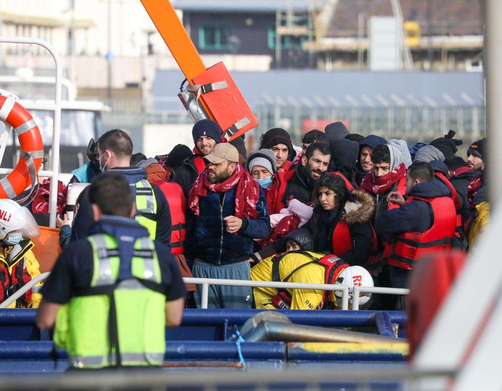 The asylum seekers, with the baby shown in the middle of the group, at the Tug Haven. Picture: UKNIP