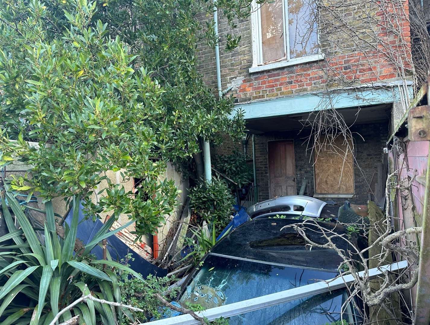 An unrecognisable car in the garden. Picture: Taylor James Auctions