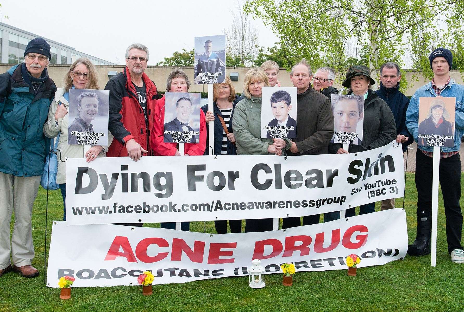 Lorraine and Melvin Sillcock holding a placard and photo of son James who committed suicide after taking acne drug Roaccutane. The couple travelled to Roche, the company which makes the drug, in a bid to get the company to look into its side effects and get it taken off UK shelves. Picture: Melvin Sillcock
