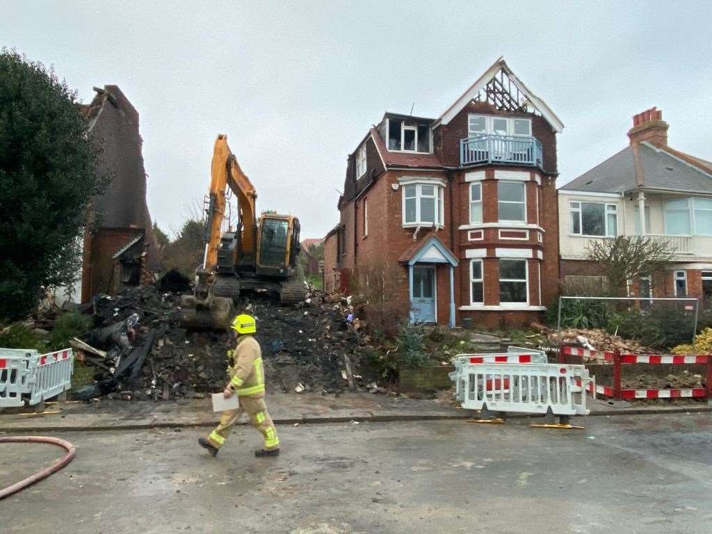 A digger at the scene as one of the homes is demolished. Pictures by Steve Salter