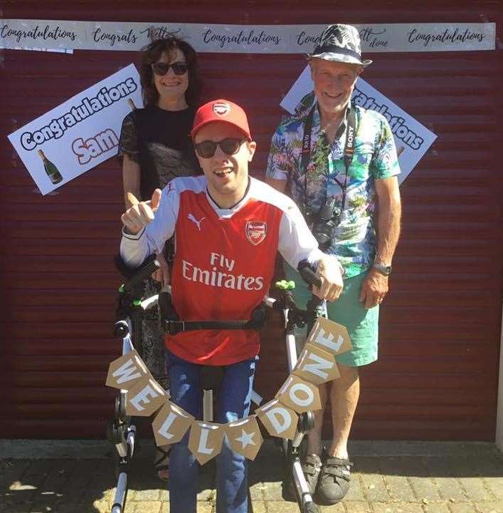 Sam Cory at the end of his challenge with grandparents Pam and Henry Williams