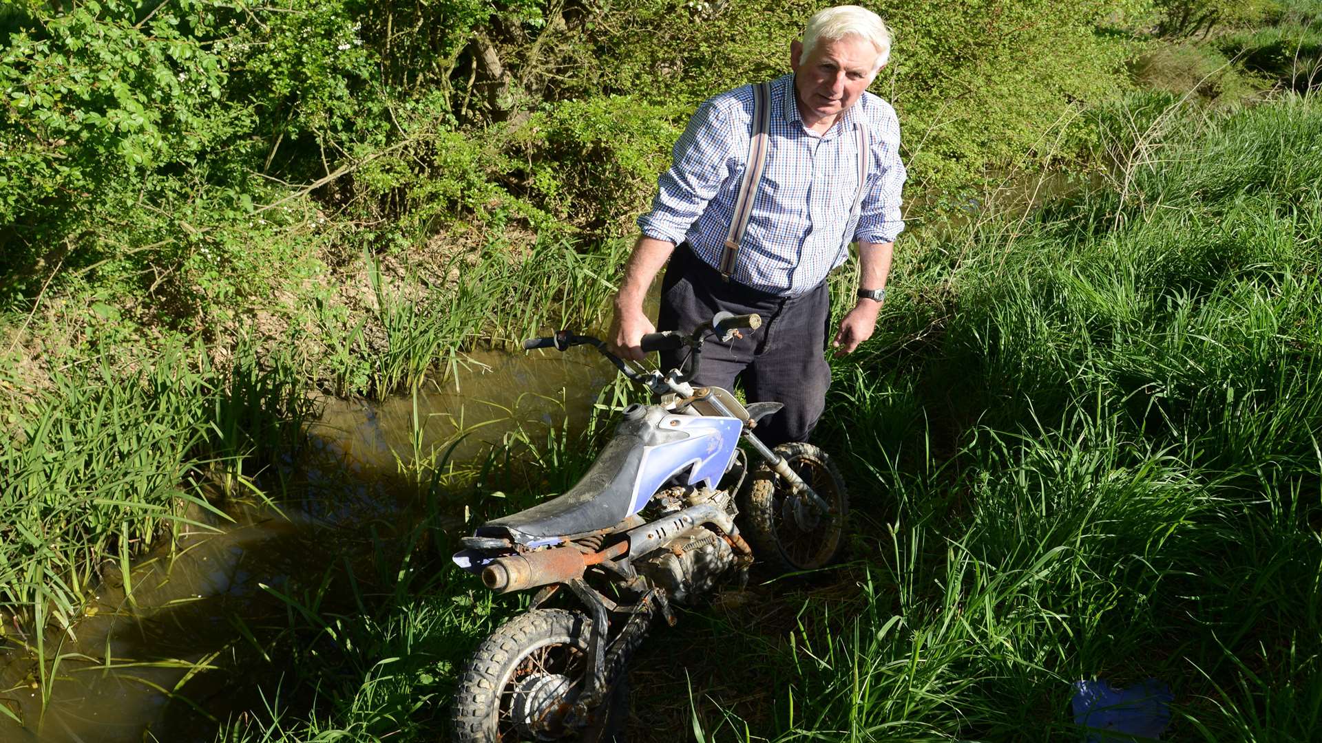 Mr Homewood with the motorbike dumped in a ditch on his farm