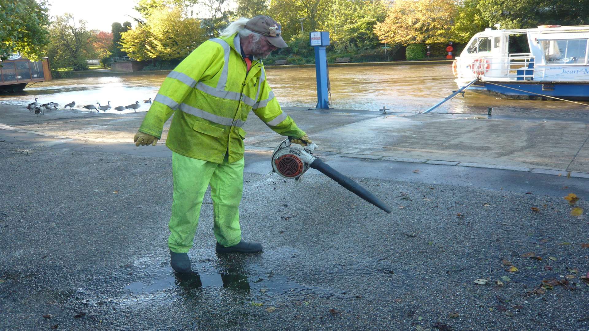 A council worker clearing leaves near the River Medway in Maidstone