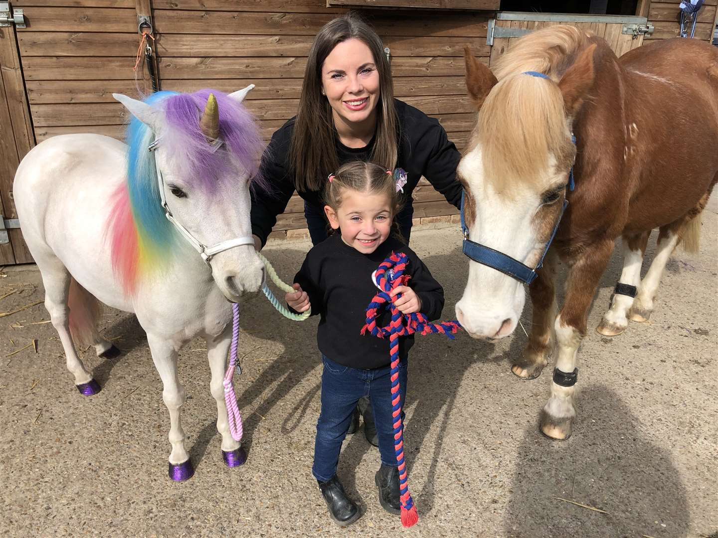 From left: Henny the unicorn, Claire and daughter Sophia and horse Joey