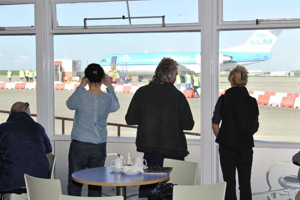 Onlookers see the last KLM flight as it prepares to take off