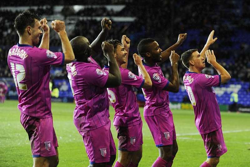 Gillingham striker Adebayo Akinfenwa, second left, and his team-mates celebrate their second goal at Tranmere. Picture: Barry Goodwin