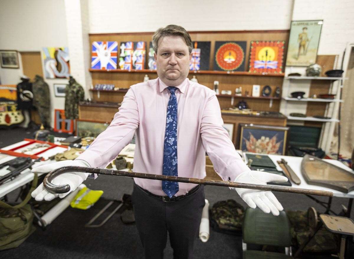 Karl Bennett, from Bloomfield Auctions in east Belfast, holds a walking stick belonging to Michael Collins (Liam McBurney/PA)