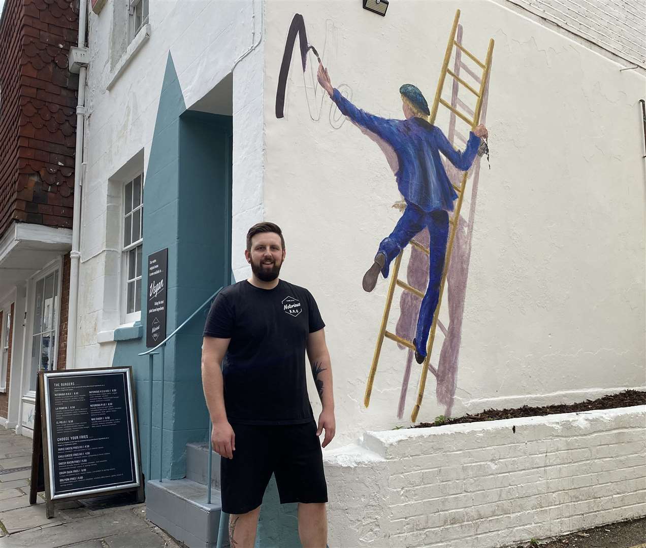 Notorious BRG owner Jonny Wall with Lief Bruylant's work at Castle Street restaurant in Canterbury