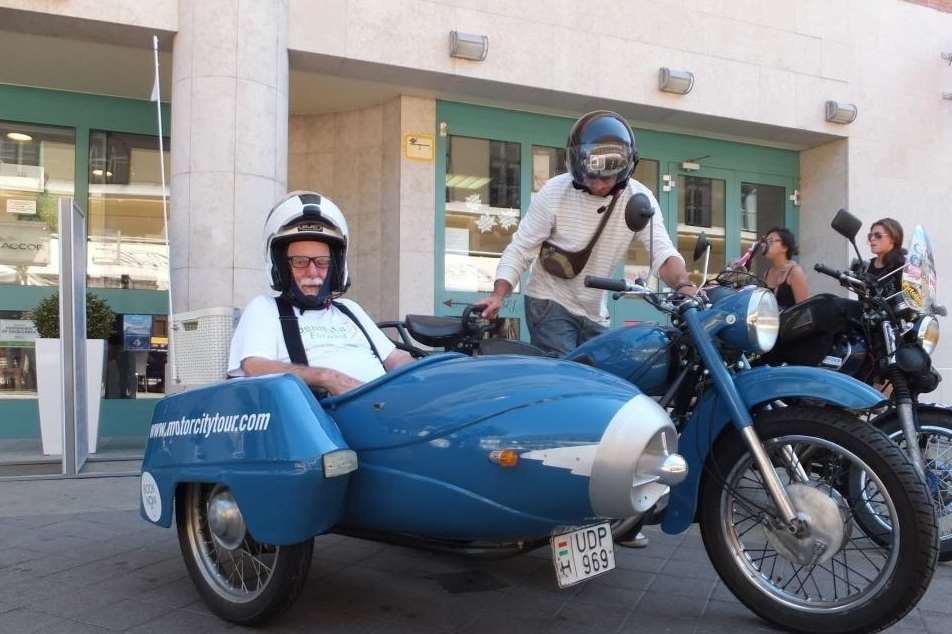 David Stokes, 68, gets a tour in a sidecar last year in Hungary