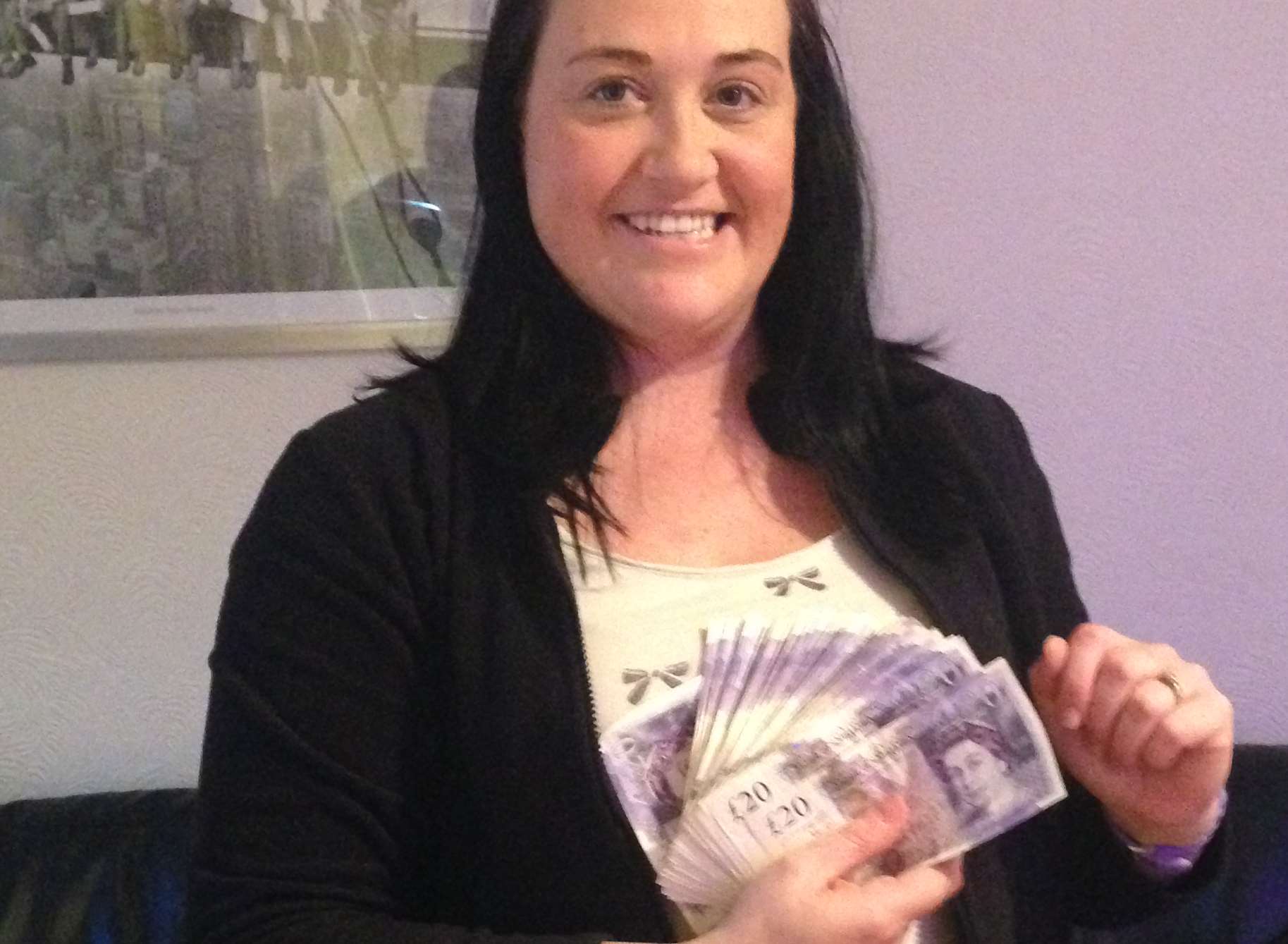 Listener Sarah Rooney with her prize after winning on kmfm's Thousand Pound Friday competition